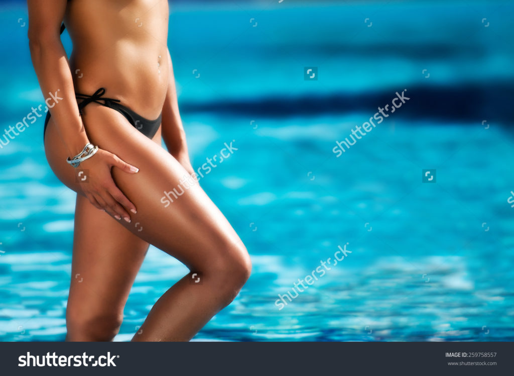 stock-photo-girl-with-beautiful-body-by-the-swimming-pool-259758557